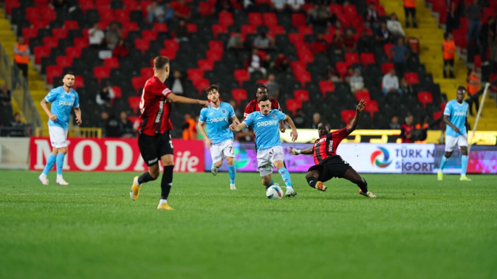 Trabzonspor ve Gaziantep FK maçında oyuncular sahada mücadele ediyor.