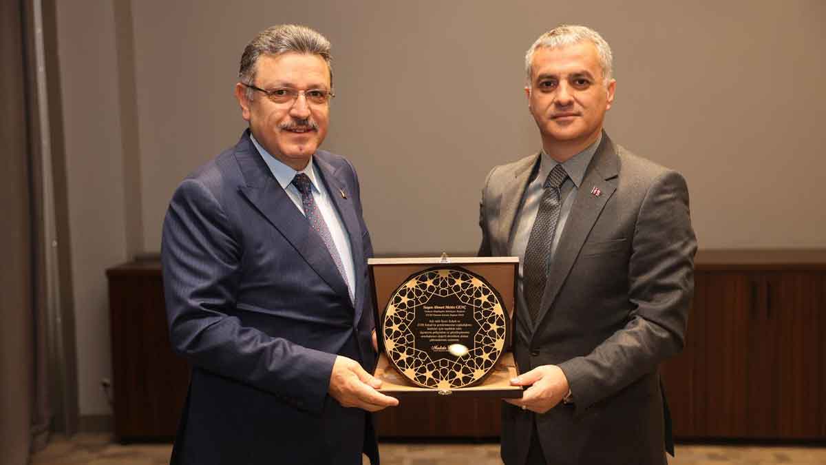 Başkan-Bıyık-Başkan-Genç'e-teşekkür-plaketi-verdi